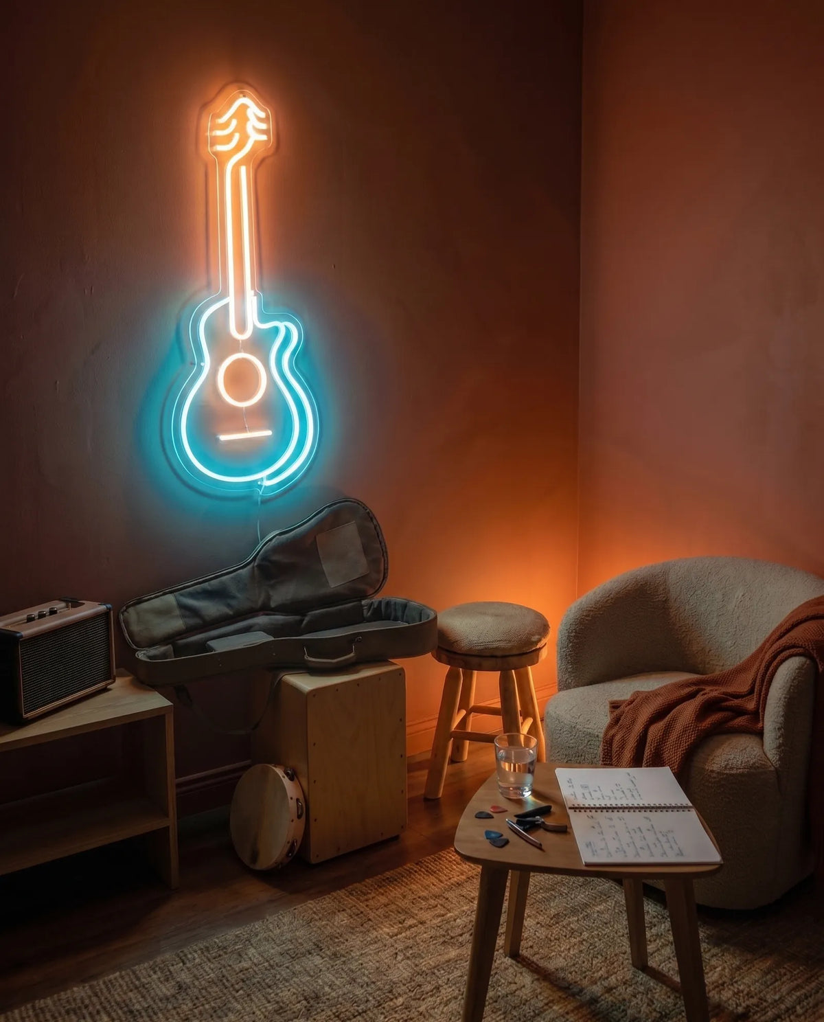 Néon LED guitare acoustique turquoise et blanc chaud dans un coin musique, fauteuil bouclé, cajon et housse ouverte